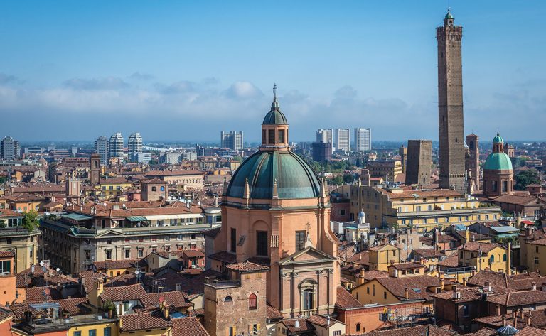 Bologna, Italy - October 1, 2019: Old town of Bologna city seen from terrace of St Petronius basilica, view with Two Towers and dome of Santa Maria della Vita church