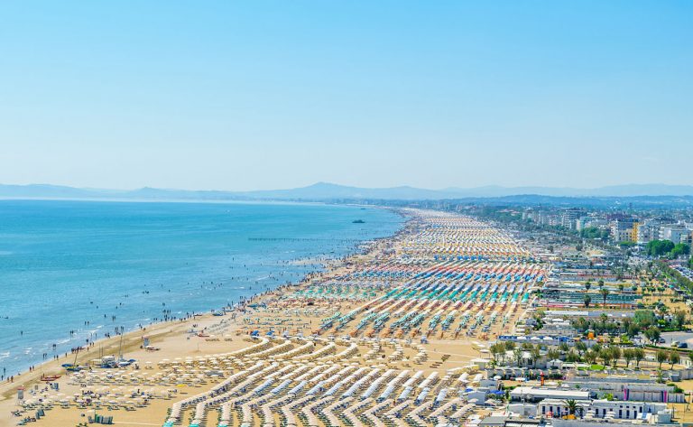 Aerial view of Rimini resort beach in Italy with a lot of parasols and sunbeds during summer time