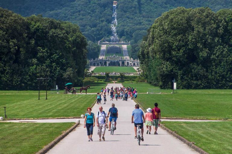 CASERTA, ITALY, JULY 1, 2014: View over artificial cascade leading to chateau built in Palazzo Reale grounds in Caserta. It was the largest palace erected in Europe during the 18th century.