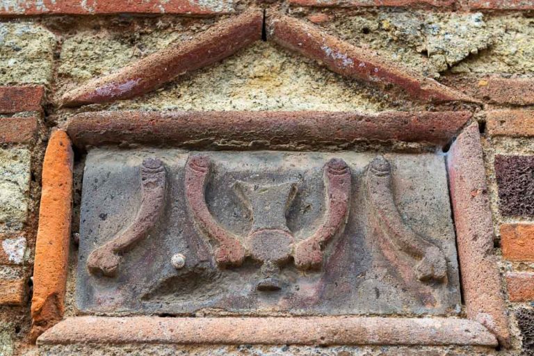 Image of mens penises on the wall of brothel in Pompeii near Naples, Italy. Pompeii is an antique Roman city died from eruption of Vesuvius. Ancient street sign with phalluses for Pompeii lupanar.