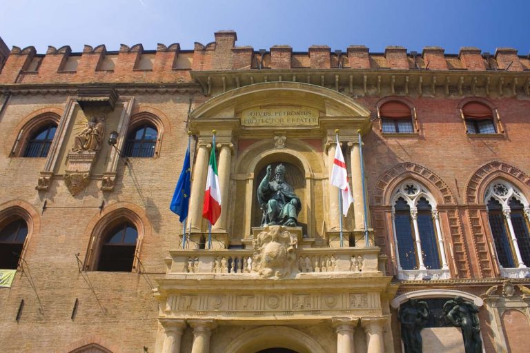 BOLOGNA, ITALY - August 28, 2019: San Petronio statue at Palazzo d'Accursio (Palazzo Comunale) at Piazza Maggiore in Bologna