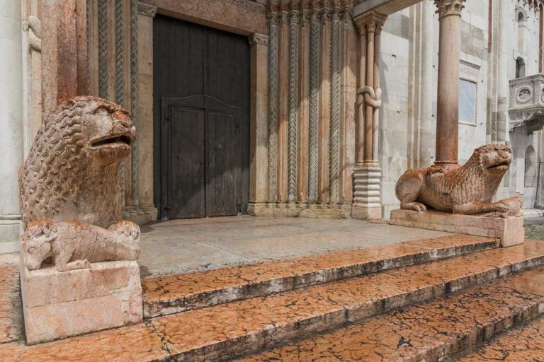 Ancient medieval statues in the shape of lions in the facade of the cathedral of Modena, ElÃ¬milia Romagna, Italy