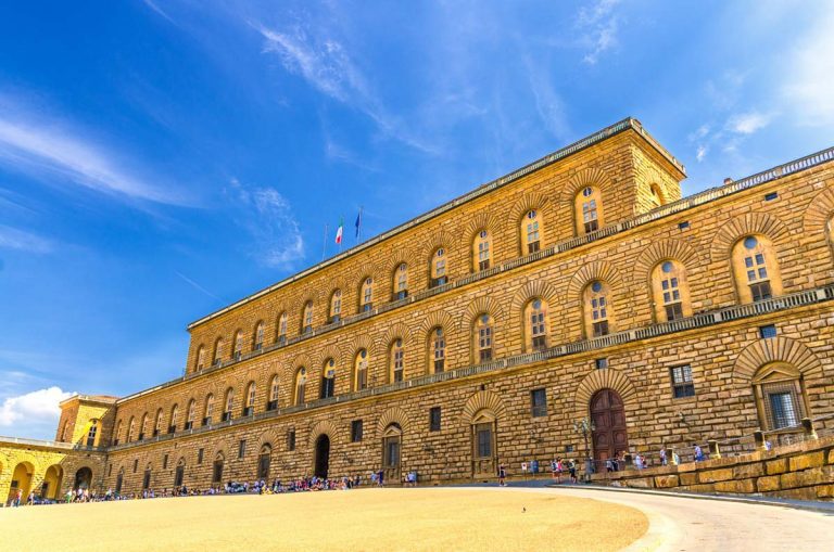 Facade of Palazzo Pitti palace with Gallery of Modern Art large building on Piazza dei Pitti square in historical centre of Florence city, blue sky white clouds, Tuscany, Italy