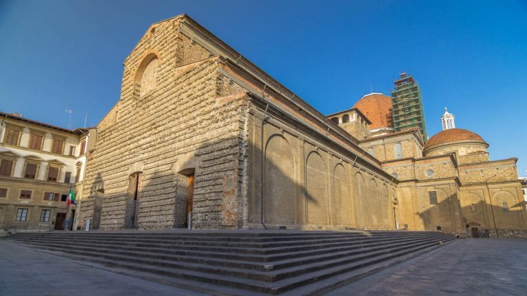 Basilica di San Lorenzo (Basilica of St Lawrence) timelapse hyperlapse in Florence city. Shadow moving on facade. Church is the burial place of all the principal members of the Medici family. Blue sky