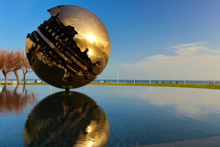The famous sphere of Arnaldo Pomodoro on the seafront of Pesaro, Marche Region, Italy