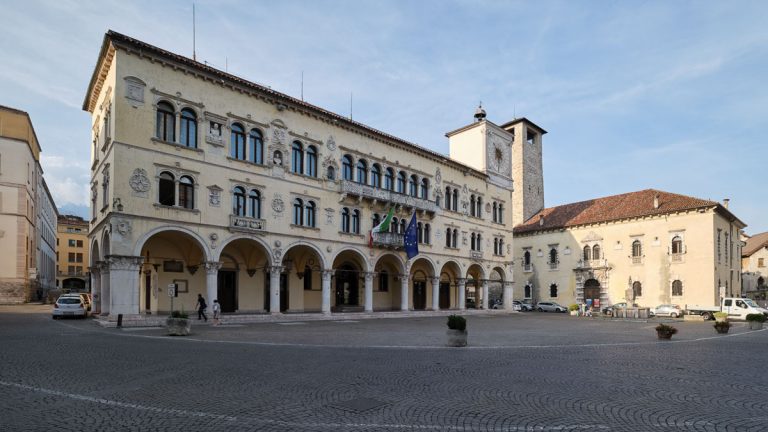 Belluno, Italy - 09-10-2020. Square "Piazza Duomo" with ancient palace "Palazzo dei Rettori" and fountain.