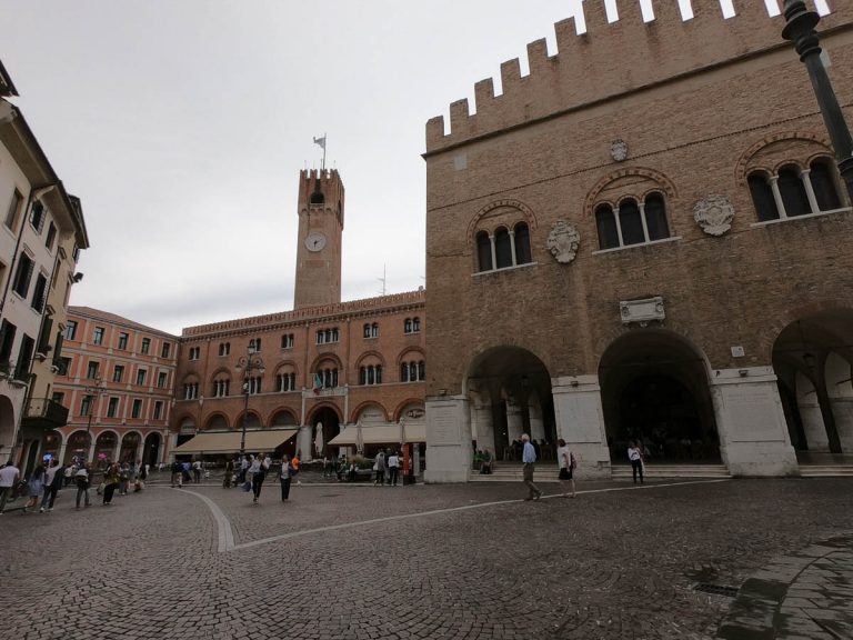 Treviso / Italy - June 22, 2019: The Palazzo della Prefettura (Prefecture Palace), the Palazzo dei Trecento and the Municipal Bell Tower (Torre Civica) of Treviso.