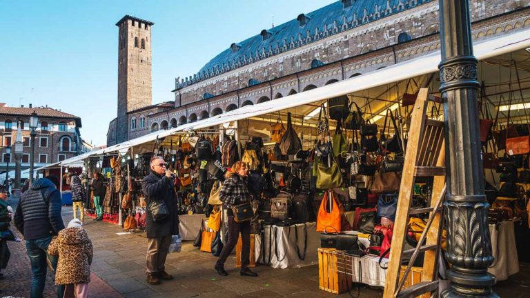 Padova, Italy - 01/05/2020: people in the market in front of the Palazzo della Ragione. Padova, Italy