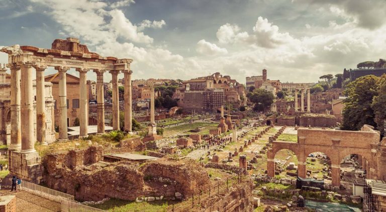 Panoramic view of Roman Forum in summer, Rome, Italy. Roman Forum is remains of famous Roman Empire. Scenery of ancient ruins in Roma city center on sunny day. Vintage style photo of Rome cityscape.