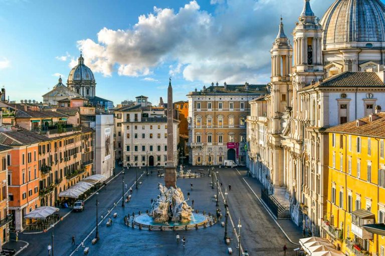 Rome, Italy - September 30 2018: View from a window overlooking the Piazza Navona early morning, showing the cathedral, sidewalk cafes, tourists and the fountain of the Four Rivers.