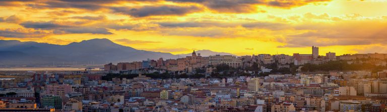 Panoramic view of Cagliari city with old Castle in background at sunset. High resolution stitched panorama.
