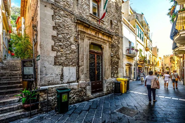 Taormina, Italy - September 18 2016: The main street, Corso Umberto, and one of the many side streets through the coastal city of Taormina, Italy on the island of Sicily