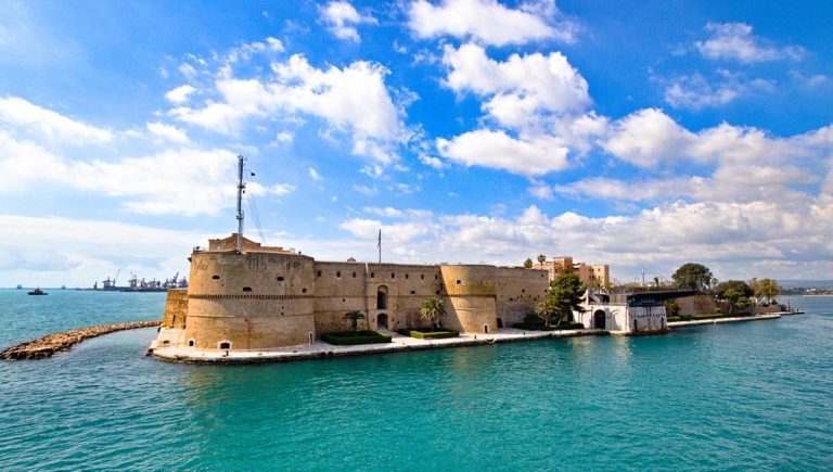 Aragonese Castle of Taranto and revolving bridge on the channel between Big and Small sea, Puglia, Italy, Blue sunny sky
