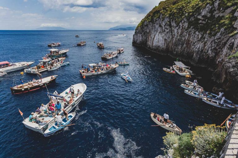 Capri, Italy - May 25, 2014: Tourists waiting on the boat outside the entrance to blue Grotto a sea cave on the coast of the island of Capri in southern Italy..