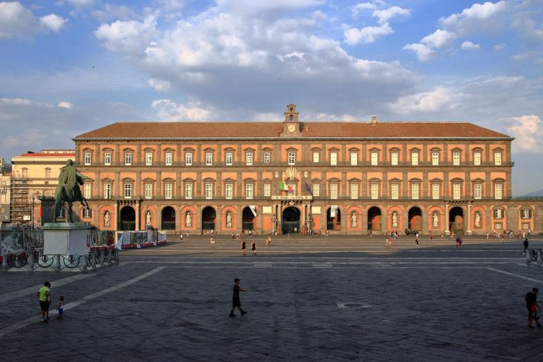 Naples,Italy - September 16,2020 :Royal Palace seen from the famous Piazza del Plebiscito . One of the largest squares in Italy. Scenes of daily life.
