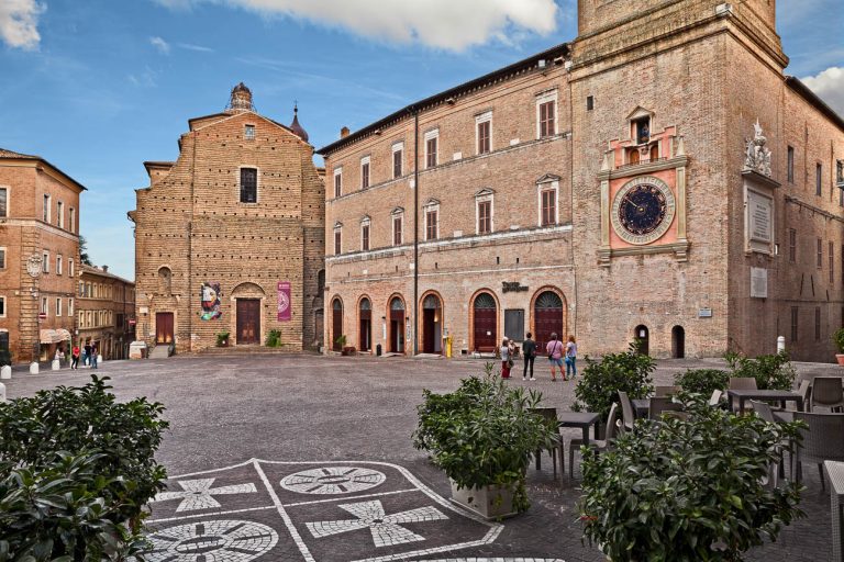 Macerata, Marche, Italy - September 28, 2019: the ancient square Piazza della liberta with the Lauro Rossi theatre, the Saint Paul church and the astronomical clock