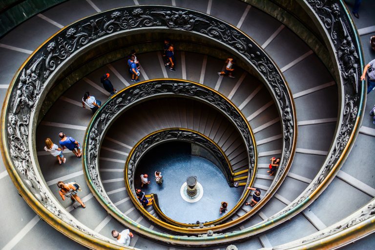 Rome / Vatican â€” August 16, 2014: the famous circular spiral Bramante Staircase in the Vatican Museums (Musei Vaticani). These spiral stairs were designed by Giuseppe Momo in 1932